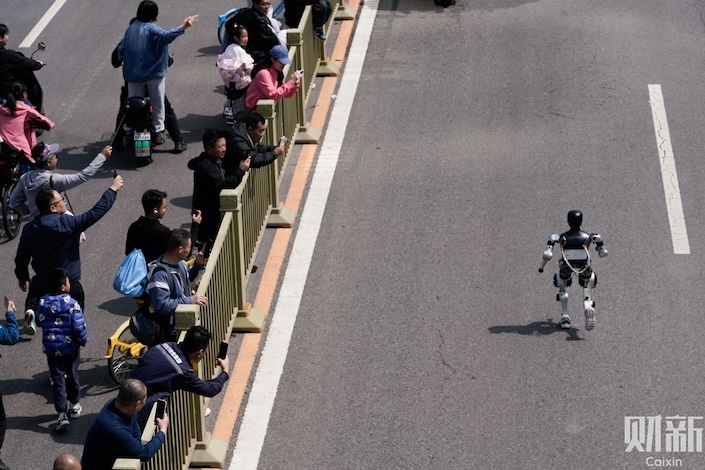 More than 20 robots joined about 12,000 human runners on a 21-kilometer (13-mile) course in suburban Beijing