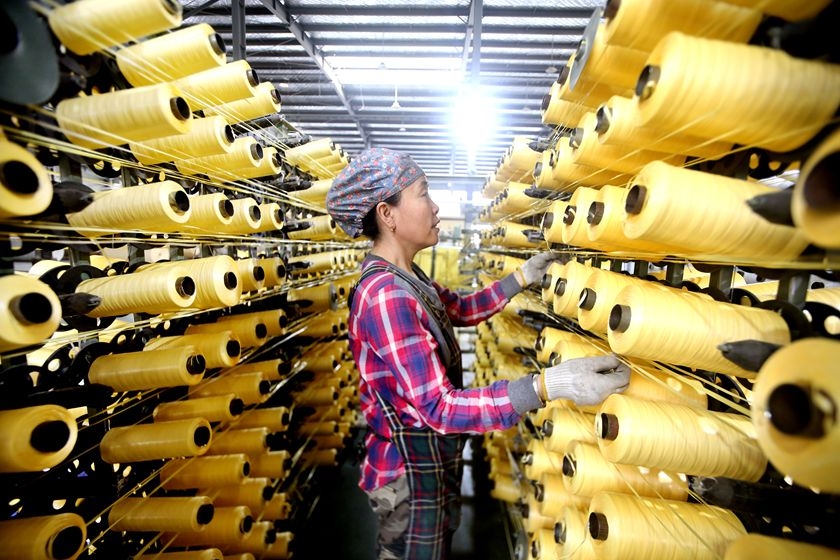 A worker produces export goods on a production line in Jiangsu province on April 27. Photo: VCG